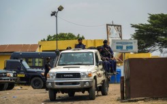 A police vehicle with officers leaves the Makala prison 