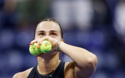 Crowd favourite: Aryna Sabalenka prepares to throw signed tennis balls to fans after defeatng Zheng Qinwen 