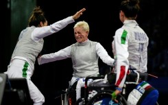 Bebe Vio (centre) congratulates her Italian teammates after winning a bronze medal in the women's wheelchair fencing