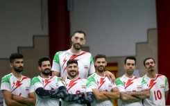 Morteza Mehrzad towers over with his teammates during a training session of Iran's national sitting volleyball team in July in Tehran 