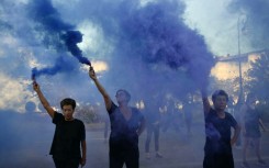 Protesters wave smoke bombs during the trial in the southern French city of Avignon of a man accused of drugging his wife Gisele Pelicot for nearly ten years and inviting strangers to rape her