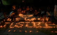 Health professionals light up earthen lamps in Kolkata calling for justice after the rape and murder of a doctor at a state-run hospital 