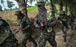 Members of the FARC dissident group Segunda Marquetalia march on a farm in Llorente, Colombia in August 2024