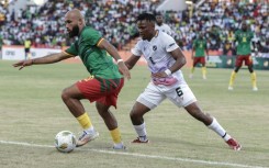 Cameroon forward Bryan Mbeumo (L) shields the ball from Namibia defender Ngero Katua during a 2025 Africa Cup of Nations qualifier in Garoua.
