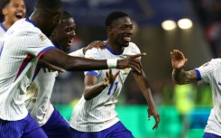 Ousmane Dembele (C) celebrates with teammates after scoring France's second goal against Belgium in Lyon