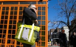 A customer carries his own reusable bag after shopping at a local supermarket on March 1, 2020 in New York City