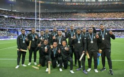 The Fiji team celebrate with their silver medals at the Stade de France following defeat to France in the final of the Paris Olympics