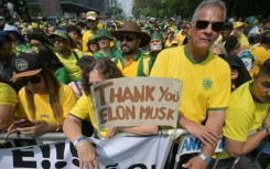 Supporters of former Brazilian President Jair Bolsonaro (2019-2022) hold a sign thanking X social media platform owner Elon Musk, during an Independence day rally in Sao Paulo, Brazil on September 7, 2024