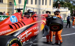 Marshalls remove the damaged Ferrari of Charles Leclerc following a crash during the first practice session for the Azerbaijan Grand Prix