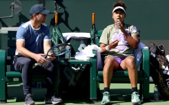 Former world number one Naomi Osaka of Japan confers with coach Wim Fissette while training at Indian Wells