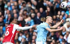 Arsenal must stop an in-form Erling Haaland (right) as the Premier League's top two face off on Sunday