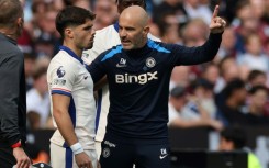 Chelsea boss Enzo Maresca (R) speaks with Pedro Neto