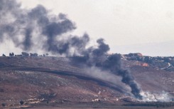 Israeli emergency services respond to a blaze in the border town of Kiryat Shmona ignited by rocket fire from Lebanon