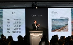 Bids are taken on "Les canots amarrés" by Vincent Van Gogh at a Christie's auction in Hong Kong