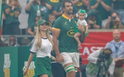 South Africa lock Eben Etzebeth walks on to the Mbombela Stadium pitch accompanied by his wife, Anlia, and baby daughter