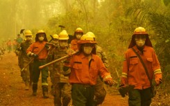 Firefighters arrive at the scene of a fire in Concepcion,  Boliva, on September 24, 2024