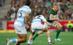 South Africa flanker Pieter-Steph du Toit (R) charges toward the Argentina try-line in Mbombela.