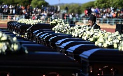 A relative mourns the 45 victims of a bus accident in Botswana in May 