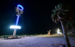 Floodlights illuminate the Umm Suqeim beach in Dubai to make it safer for beachgoers at night when the scorching heat of the Gulf has abated