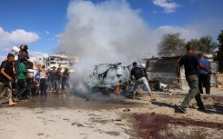 Palestinians at the site of an Israeli strike in Gaza's southern Khan Yunis on October 1