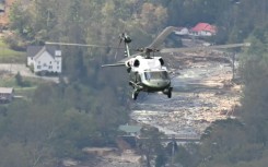 Marine One, carrying US President Joe Biden, flies above a storm impacted area near Asheville, North Carolina