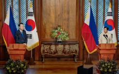 Philippine President Ferdinand Marcos (R) alongside his South Korean counterpart Yoon Suk Yeol in Manila on October 7