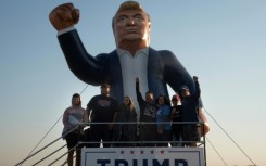 People attend a rally hosted by Republican presidential nominee Donald Trump at Dodge County Airport on October 06, 2024 in Juneau, Wisconsin