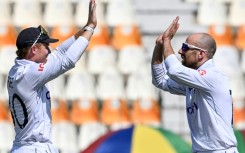 England's captain Ollie Pope celebrates with teammate Jack Leach (R) after winning the first Test cricket match against Pakistan 