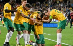 Australia's Craig Goodwin (kneeling) celebrates scoring against China 