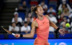 China's Zheng Qinwen hits a return to Italy's Jasmine Paolini during their women’s singles quater-final match at the Wuhan Open tennis tournament