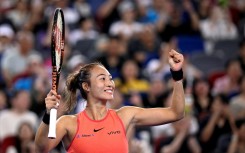 China's Zheng Qinwen celebrates after beating compatriot Wang Xinyu during their women's singles semi-final match at the Wuhan Open tennis tournament