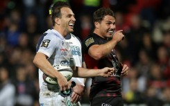 Joy: Antoine Dupont shares a joke with Clermont fly-half Benjamin Urdapilleta 