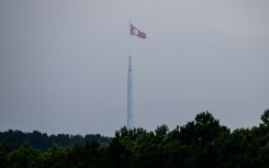 A North Korean flag seen from Paju in South Korea flutters over the village of Gijungdong in July 2024