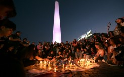 Fans light candles as they pay tribute to the late British singer Liam Payne at the Obelisco in Buenos Aires 