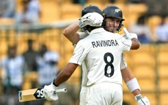 New Zealand's Will Young and Rachin Ravindra celebrate their team's win against India