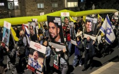 Protesters, calling for action to release hostages held in Gaza, march outside the Israeli Prime Minister's residence in central Jerusalem 