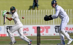 Pakistan's Saud Shakeel (L) plays a shot as England's wicketkeeper Jamie Smith looks on during the second day of the third and final Test