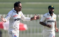 Pakistan's Noman Ali (L) celebrates after taking the wicket of England's captain Ben Stokes 