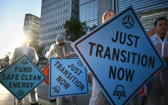 Activists protest against investment in fossil fuels outside of the World Bank headquarters in Washington, DC