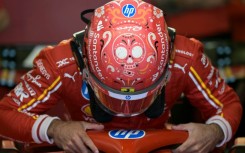 Ferrari's Spanish driver Carlos Sainz boards his car during the second practice session for the Formula One Mexico City Grand Prix