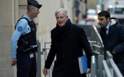 Michel Barnier (C) has been back at work since Monday after his weekend operation