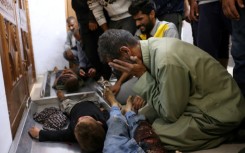 Palestinians at Nasser Hospital in Khan Yunis, southern Gaza, react in front of the bodies of children killed in an Israeli strike