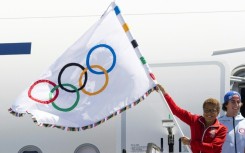 Los Angeles Mayor Karen Bass, whose city will host the 2028 Summer Games, holds the five-ringed Olympic banner