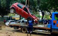 Police remove flood-damaged cars in Alfafar, in the region of Valencia