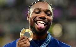 Noah Lyles with his Olympic 100m gold medal - but it wasn't enough to earn him a chance to win the men's track athlete of the year award