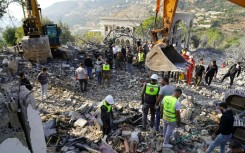 A destroyed car lies among debris a day after Israeli air strikes targeted the Lebanese village of Knaisseh near Baalbek, in Lebanon's eastern Bekaa Valley