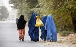 Afghan women walk in the outskirts of the northern city of Mazar-i-Sharif in October 2024