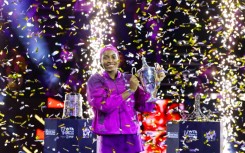 Coco Gauff poses with the trophy after defeating China's Zheng Qinwen to win the WTA Finals title