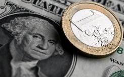 The euro hit a one-year dollar low on Tuesday, dropping below $1.06