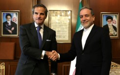 International Atomic Energy Agency chief Rafael Grossi (L) shakes hands with Iranian Foreign Minister Abbas Araghchi before their meeting in Tehran.